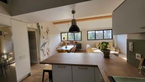 a kitchen with a wooden counter top in a room at BAMBOU SERENITE ECO LOGIS -Piscine in Elne