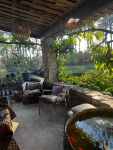a patio with a couch and a fish pond at Chez Sophie in Rosières