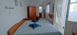 a bedroom with a bed with two pillows on it at Casa Vasilios Charokopos in Mesochórion +7 photos