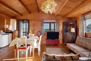 a living room with a table and a couch at Casa da Lagoa Pateira in Fermentelos