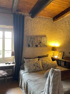 a bedroom with a bed and a yellow wall at Chez Sophie in Rosières