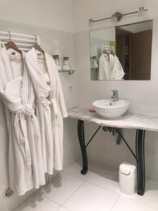 a bathroom with white towels on a counter and a sink at LE GRAND PARIS LA MAISON DE VACANCES in Digne-les-Bains +10 photos