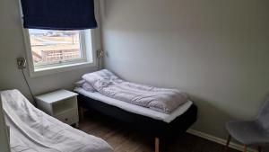 Postel nebo postele na pokoji v ubytování Bensvik Brygge