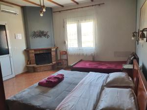 A bed or beds in a room at Alexandros Guesthouse