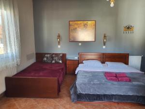 A bed or beds in a room at Alexandros Guesthouse