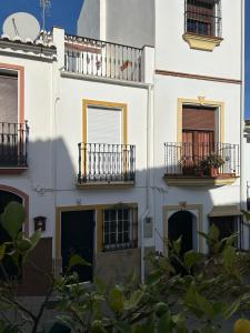 a white building with balconies and windows at Casita Maite in Ardales +12 photos