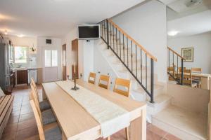 a kitchen and dining room with a table and a staircase at Scenic Two Bedroom Villa with Private Pool in Sutivan