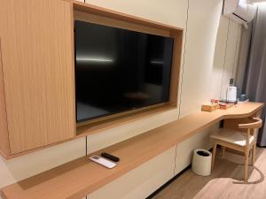 a large flat screen tv on a wall in a room at Ruby Hotel in Vientiane