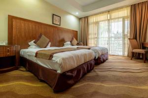 Postel nebo postele na pokoji v ubytování Mbale Resort Hotel