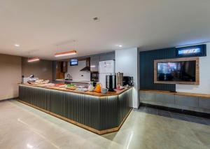 a restaurant with a counter with a food at EViM HOTEL ÇORLU in Çorlu