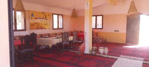 a dining room with a table and chairs in a room at Mhamid Regency Camp in Mhamid
