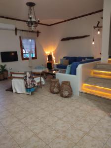 a living room with a couch and a fireplace at Zephyrus Sunset House. Amazing View and Privacy! in Agkidia