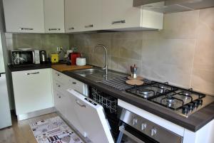 a kitchen with a stove and a sink at Casa Sofia nel centro di Formia in Formia