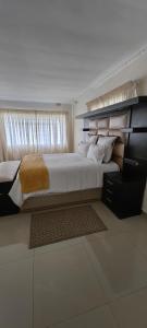 a bedroom with a large bed and a window at 55 On Paisley in Bulawayo