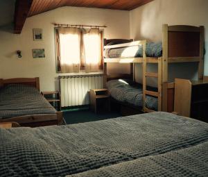 a room with two bunk beds and a window at Hôtel Le Monte Pente in Vars +18 photos