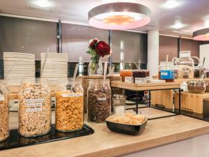 a counter with many different types of food at Holiday Inn Express Saint-Nazaire by IHG in Saint-Nazaire