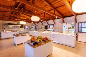 a large kitchen with bowls of fruit on a counter at Club del Sole Orbetello Family Collection in Orbetello
