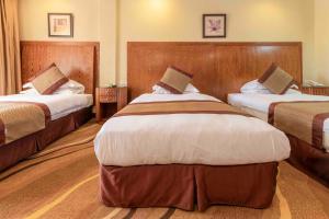 Postel nebo postele na pokoji v ubytování Mbale Resort Hotel