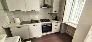 a small kitchen with a stove and a sink at MS Piazza del Papa Sea Port in Ancona +14 photos