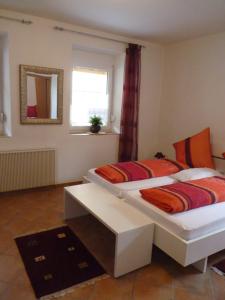 a bedroom with two beds and a mirror and a window at Ferienwohnung Monteurwohnung in Pforzheim