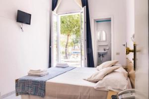 Postel nebo postele na pokoji v ubytování Hotel Bianca Orchidea