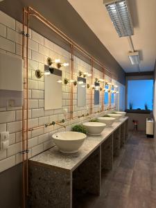 a row of sinks in a public bathroom at UrbanKey Pods - Vienna Neubau in Vienna