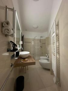 a bathroom with a sink and a toilet and a tub at B&B Da Gina in Senigallia +32 photos