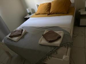 a bedroom with a bed with two towels on it at Villa Confortable à Deshaies avec Piscine Privée in Deshaies +17 photos