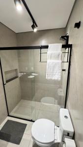 a bathroom with a shower with a toilet and a sink at Pousada Vale das Águas in Águas de São Pedro