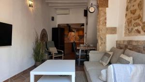 a living room with a couch and a table at Casita Pin i Pon Town House, Javea in Jávea