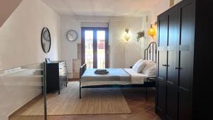 a bedroom with a bed and a dresser and a mirror at Casita Pin i Pon Town House, Javea in Jávea