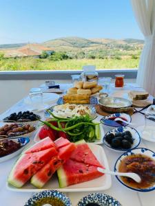 a table with a bunch of food on it at QonuQ Bozcaada in Bozcaada
