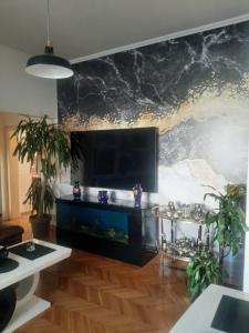 a living room with a fish tank on a wall at Stylish King Downtown in Podgorica