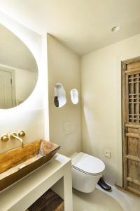 a bathroom with a wooden sink and a toilet at Solace in Totnes