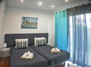 a living room with a couch with towels on it at Exceptional villa in Vila Franca Do Campo with private pool in Vila Franca do Campo