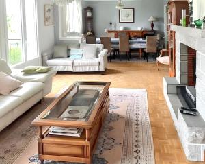 a living room with a couch and a coffee table at Villa élégante à Mur-de-Barrez avec piscine privée in Mur-de-Barrez