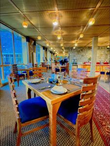 a dining room with a wooden table and chairs at Eagle's Nest Hotel in Karimabad Hunza