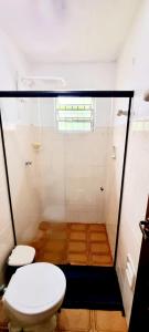 a bathroom with a toilet and a shower at Casa Jardim do Mar - Ubatuba - Praia Grande in Ubatuba