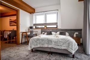 Posteľ alebo postele v izbe v ubytovaní Apartamenty Pod Tatrzańskim Niebem