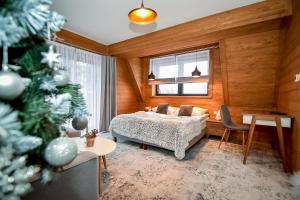 Posteľ alebo postele v izbe v ubytovaní Apartamenty Pod Tatrzańskim Niebem