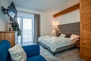 Posteľ alebo postele v izbe v ubytovaní Apartamenty Pod Tatrzańskim Niebem