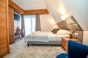 Posteľ alebo postele v izbe v ubytovaní Apartamenty Pod Tatrzańskim Niebem