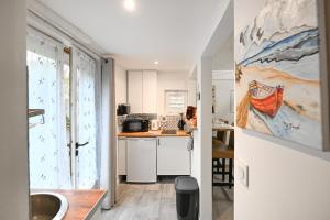 a kitchen with a sink and a counter top at La P'tite Escapade - à 25 min de Caen in Creully