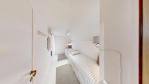 a white living room with a white couch in a room at Villa Marina in Campu Longu