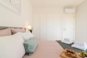 a bedroom with a bed with a tray of food on it at Bright & Spacious Retreat with Balcony by HostWise in Porto +31 photos