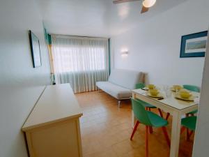 a living room with a white table and chairs at Apartamentos Eldorado in Lloret de Mar