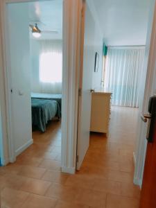 a room with a room with a bed and a floor at Apartamentos Eldorado in Lloret de Mar