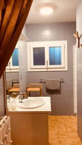 a bathroom with a sink and a mirror at Métairie de Moutiques in Cazaubon