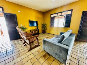 a living room with a couch and a chair at Casa Bela Araçagy, 400m da praia. in São-José-do-Ribamar