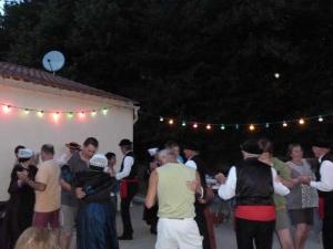 a group of people standing around a tent at night at Camping 3 étoiles - Piscine - cca0gbb in Apremont +49 photos